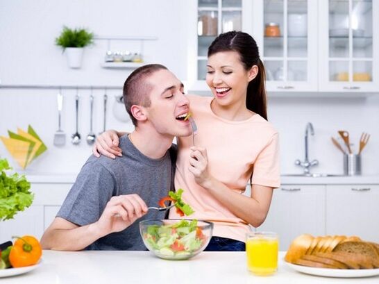 a woman feeds a man with products to naturally increase potency