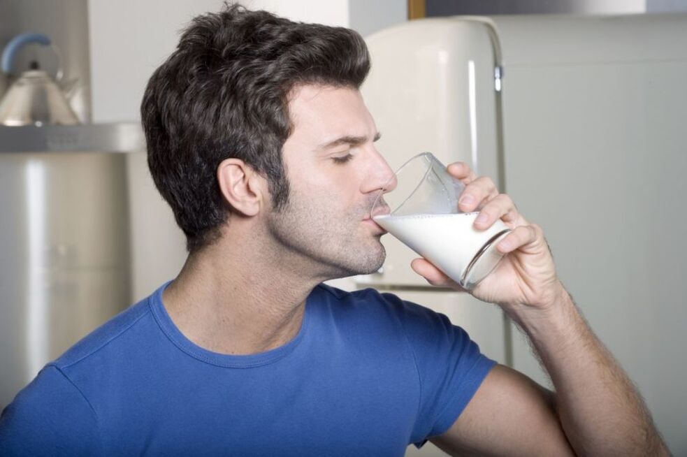 The man drinks milk
